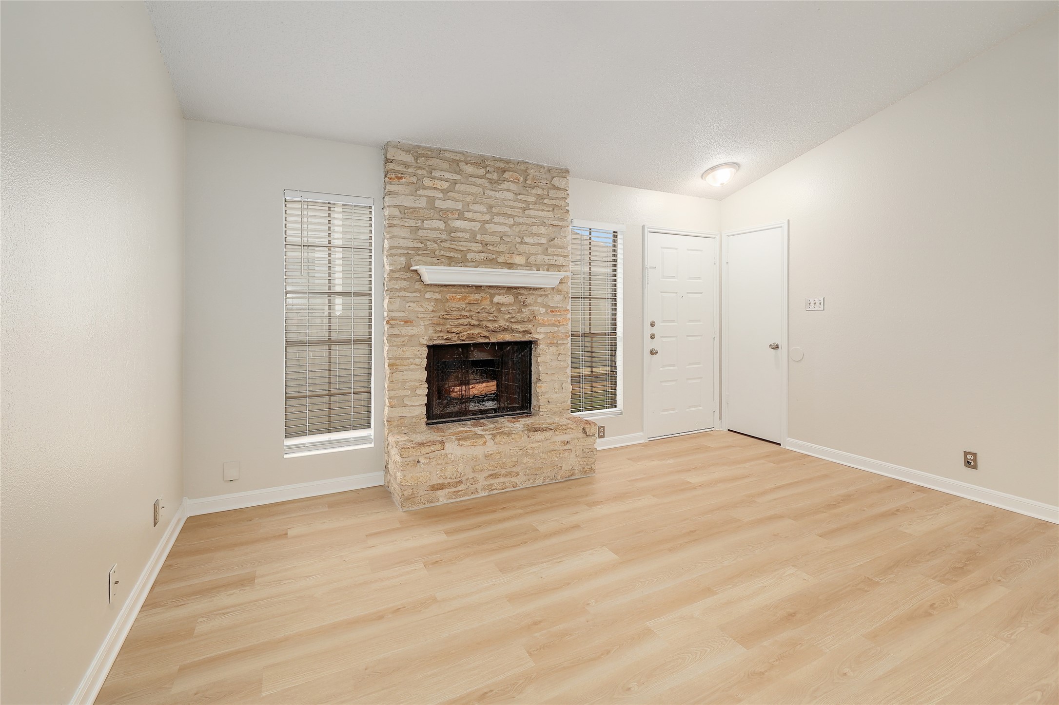 1915 Margalene Way Austin, TX 78728 - Photo 8 of 23 an empty room with windows and fireplace
