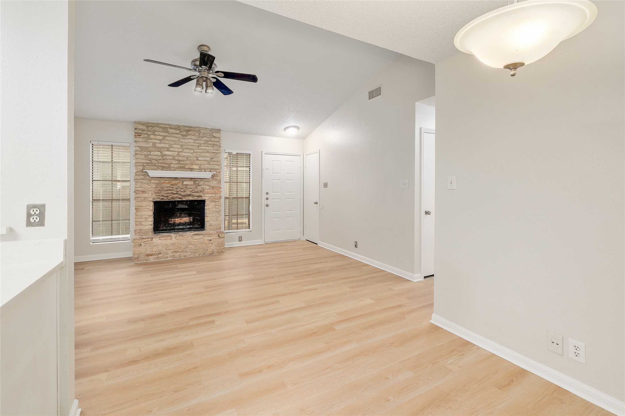1915 Margalene Way Austin, TX 78728 - Photo 9 of 23 a view of empty room with fireplace and wooden floor