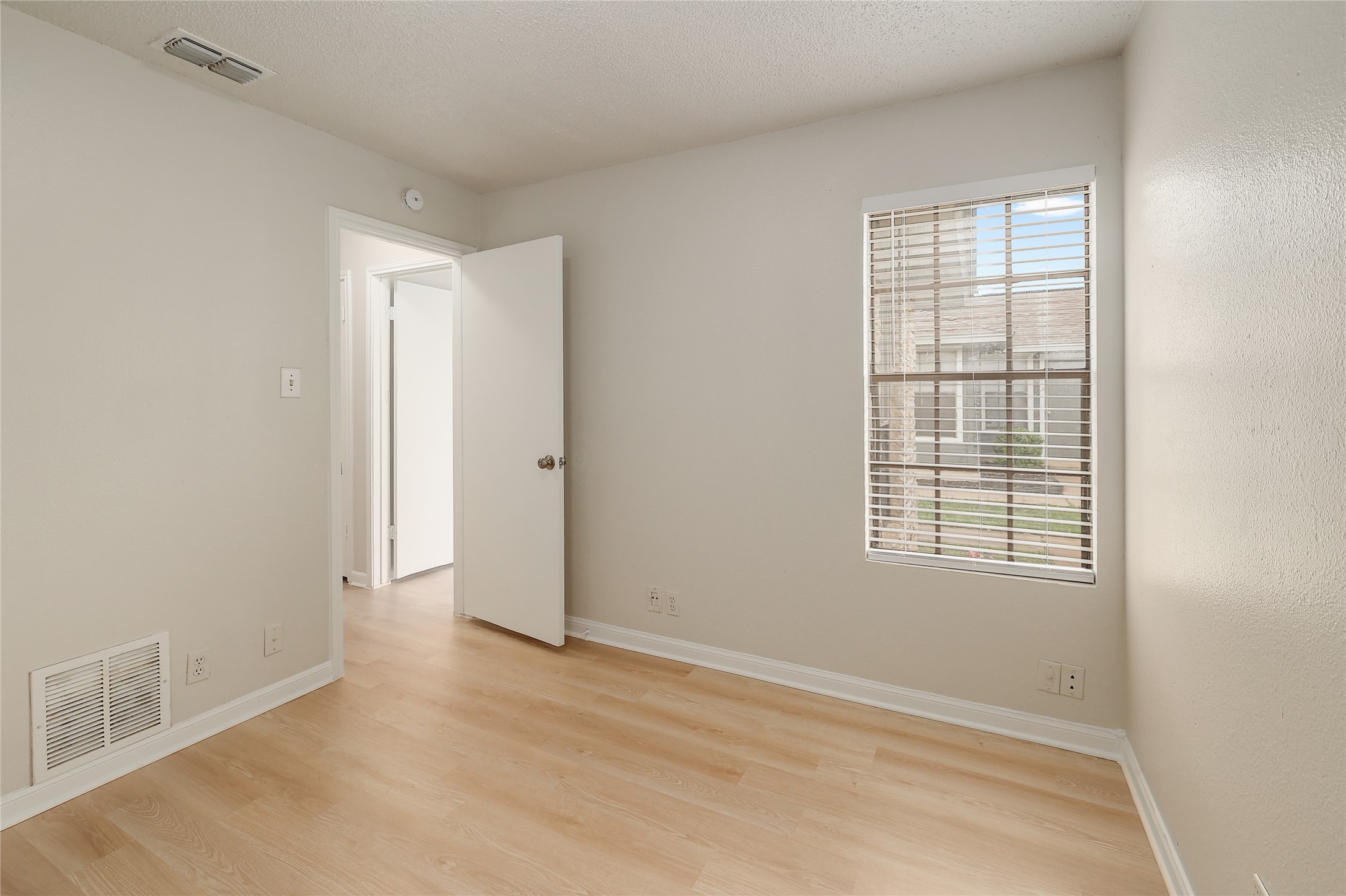 1915 Margalene Way Austin, TX 78728 - Photo 10 of 23 an empty room with wooden floor and windows