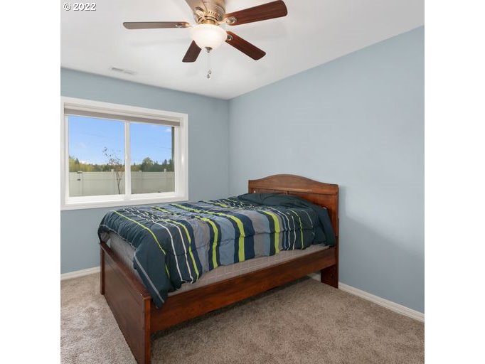 208 Northeast Carty Road Ridgefield, WA 98642 - Photo 21 of 32 a bedroom with a bed and window
