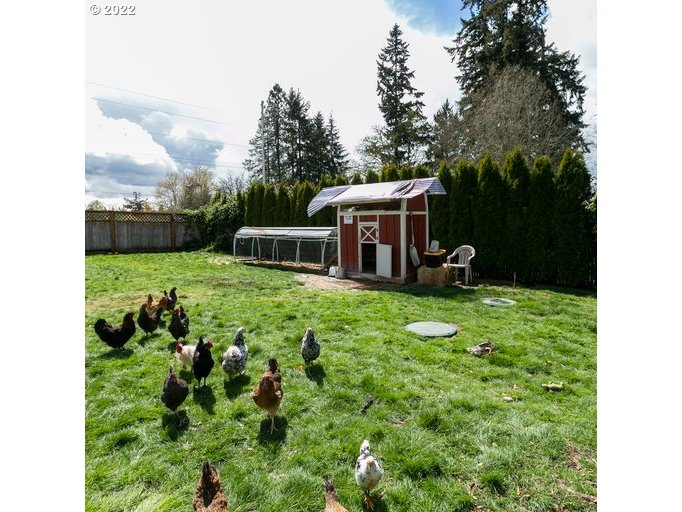 208 Northeast Carty Road Ridgefield, WA 98642 - Photo 29 of 32 a backyard of a house with table and chairs