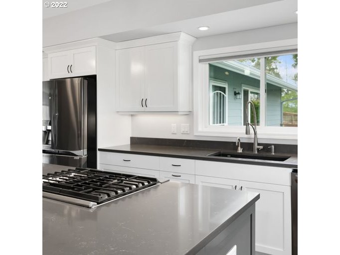 208 Northeast Carty Road Ridgefield, WA 98642 - Photo 7 of 32 a kitchen with granite countertop a sink stove and refrigerator
