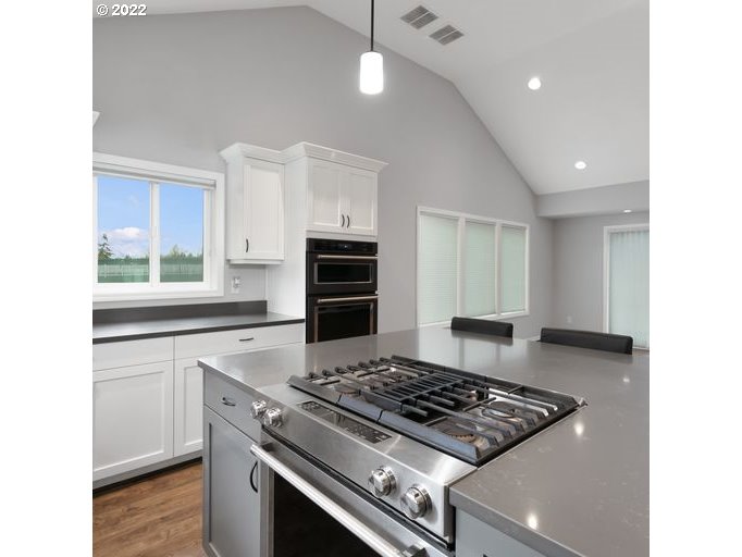 208 Northeast Carty Road Ridgefield, WA 98642 - Photo 8 of 32 a kitchen with a stove and a refrigerator