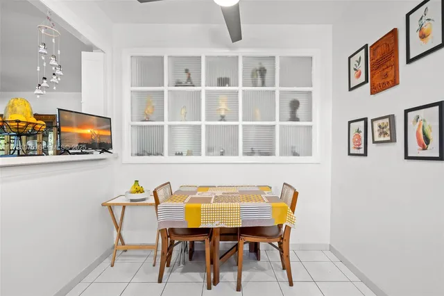 a view of a dining room with furniture and a flat screen tv