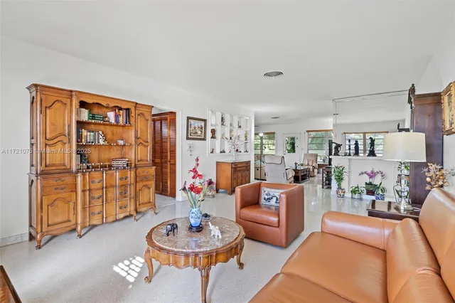 a living room with furniture and a kitchen