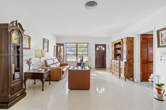 a living room with furniture and large window