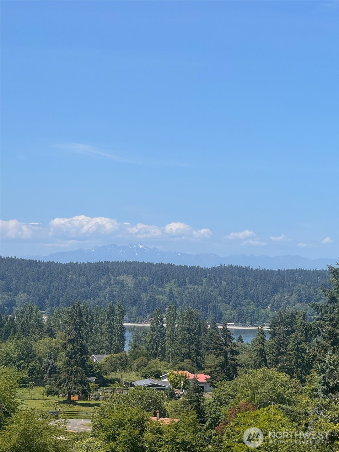 9438 Southwest 266th Lane Vashon, WA 98070 - Photo 3 of 24 a view of a town with mountains in the background