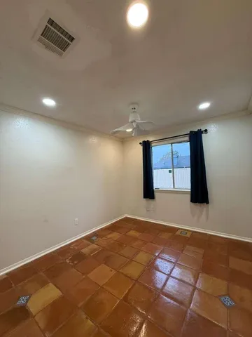 a bedroom with a large bed and a potted plant