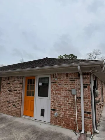 a front view of a house with plants