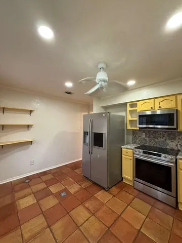 a kitchen with stainless steel appliances granite countertop a stove and a sink