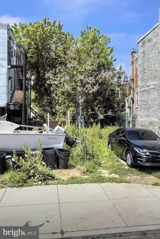 a view of a backyard with plants and a fountain