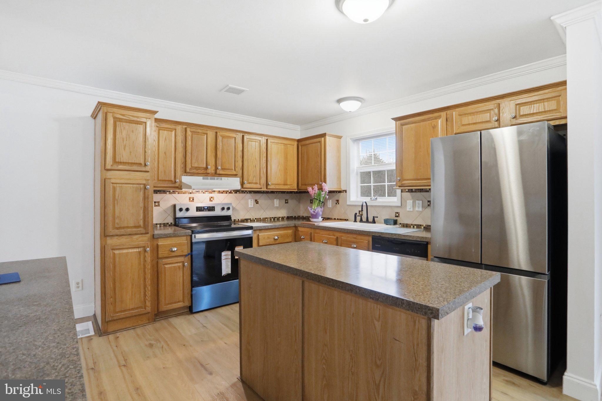 271 Packing Shed Road Berkeley Springs, WV 25411 - Photo 8 of 38 Warm wood tones in a modern kitchen.