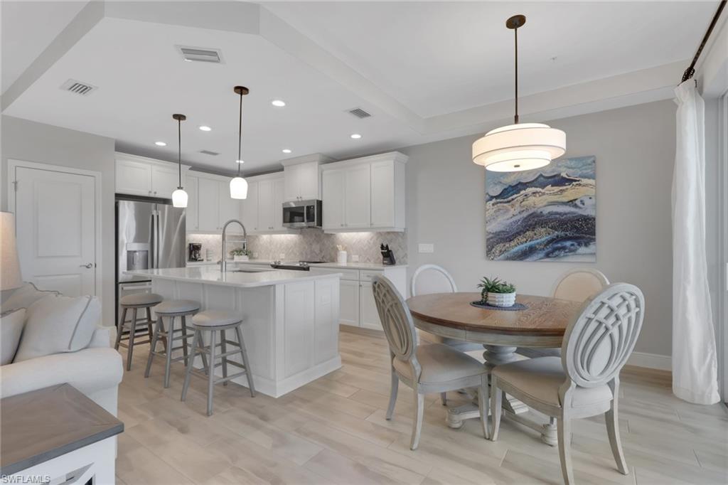 2647 Seychelles Circle, Unit 2202 Naples, FL 34112 - Photo 10 of 37 Dining area featuring light wood-style floors and recessed lighting