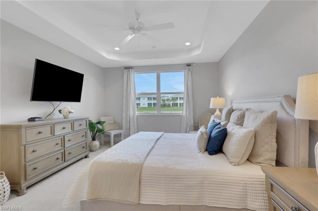 2647 Seychelles Circle, Unit 2202 Naples, FL 34112 - Photo 13 of 37 Bedroom with recessed lighting, ceiling fan, light colored carpet, and a raised ceiling