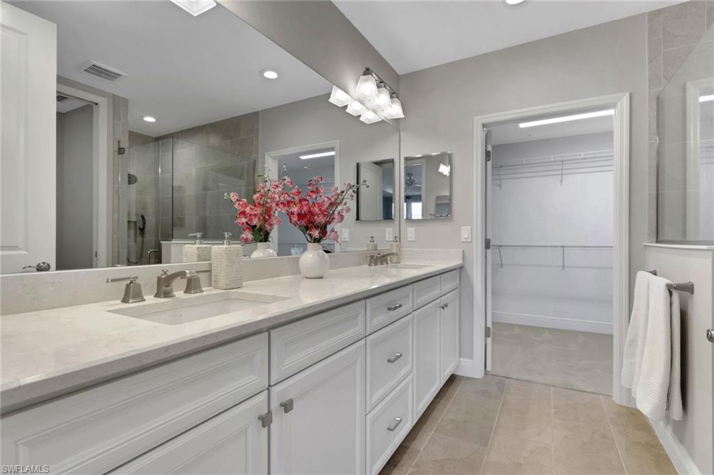 2647 Seychelles Circle, Unit 2202 Naples, FL 34112 - Photo 14 of 37 Full bathroom with a shower stall, double vanity, a spacious closet, light tile patterned flooring, and recessed lighting