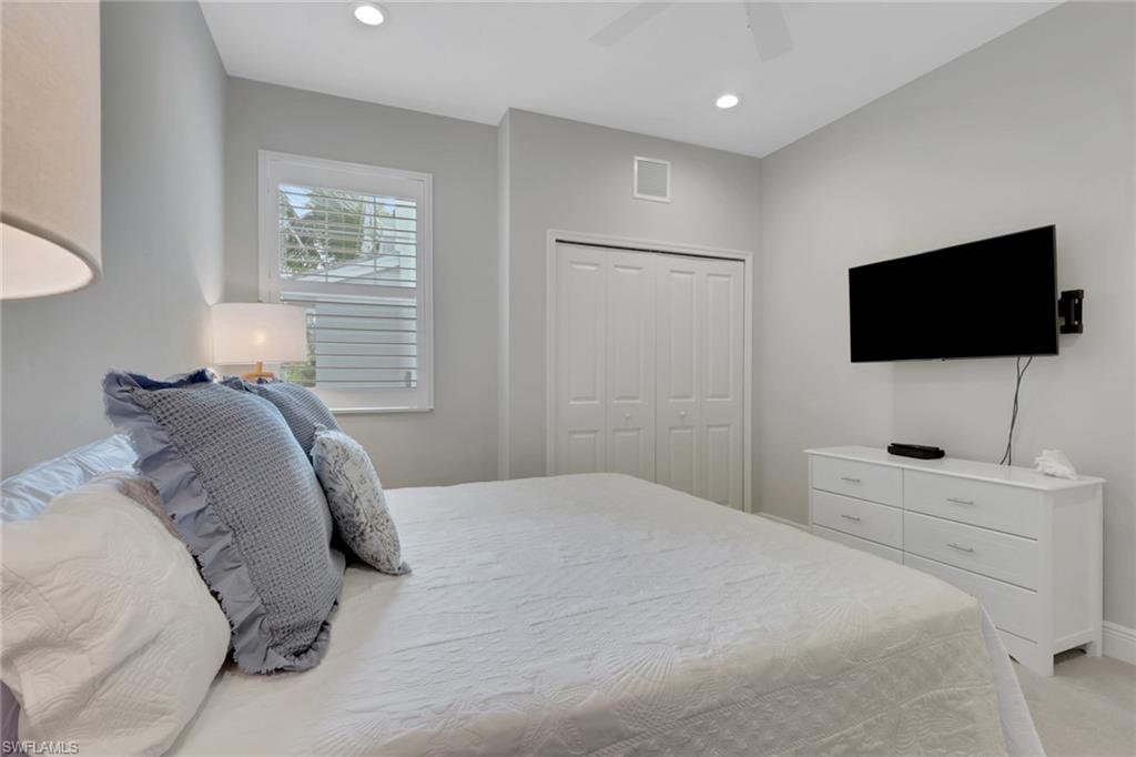 2647 Seychelles Circle, Unit 2202 Naples, FL 34112 - Photo 17 of 37 Bedroom with a closet, a ceiling fan, recessed lighting, and light colored carpet