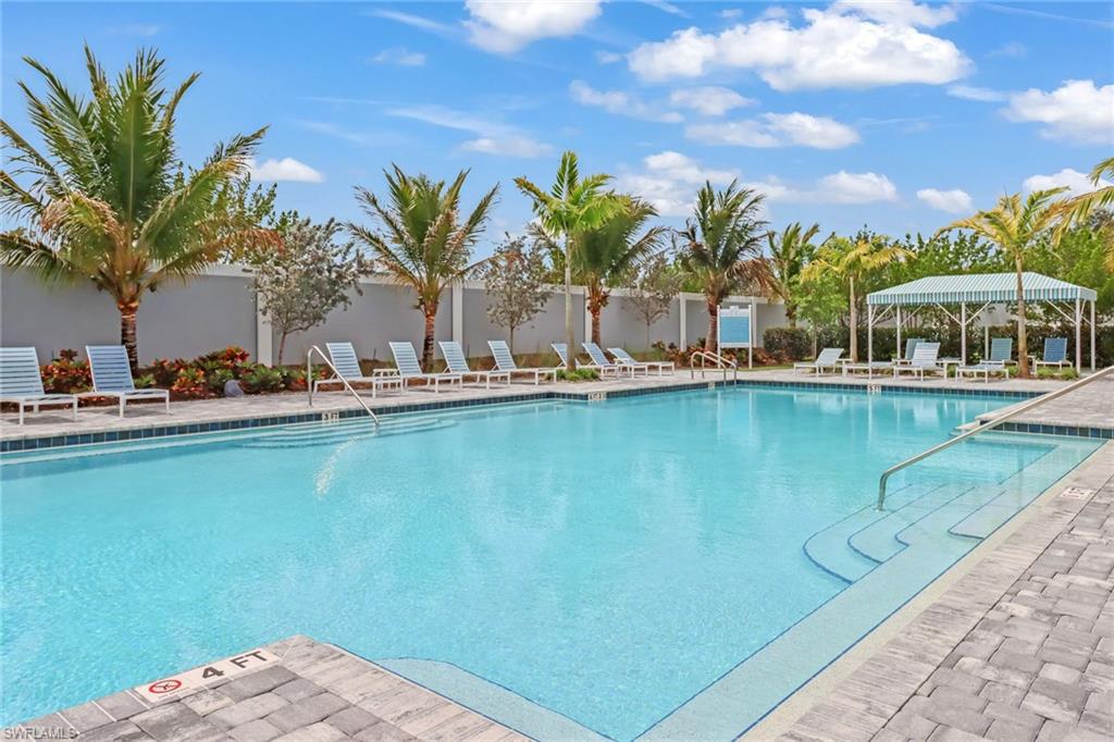 2647 Seychelles Circle, Unit 2202 Naples, FL 34112 - Photo 30 of 37 Community pool featuring a patio area