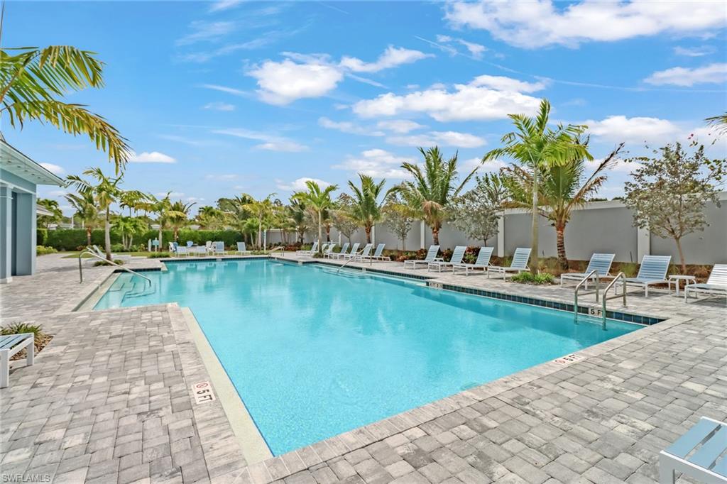 2647 Seychelles Circle, Unit 2202 Naples, FL 34112 - Photo 31 of 37 Community pool featuring a patio area