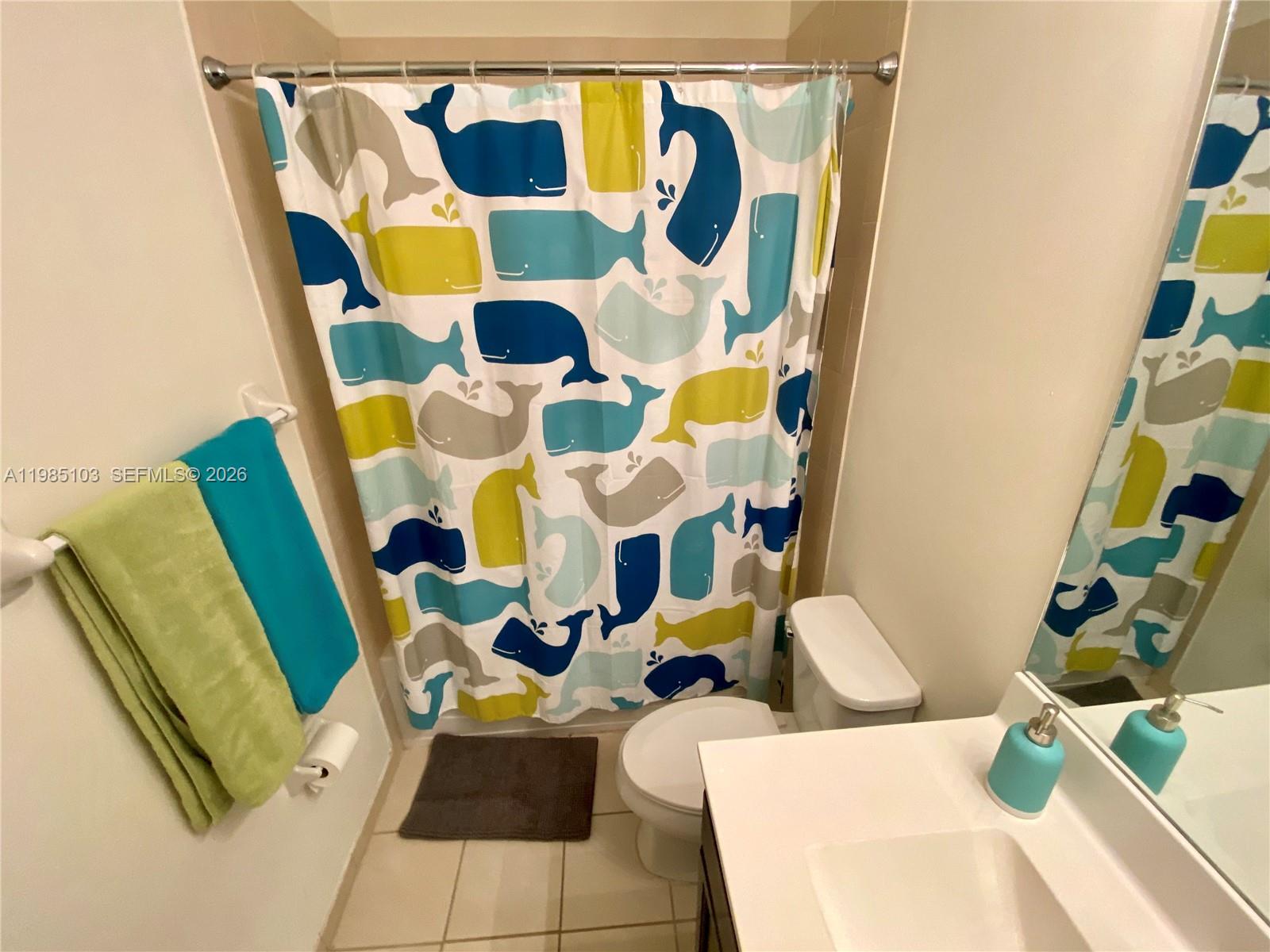 11489 Southwest 250th Street, Unit 11489 Homestead, FL 33032 - Photo 13 of 24 a bathroom with a sink and mirror with bathtub