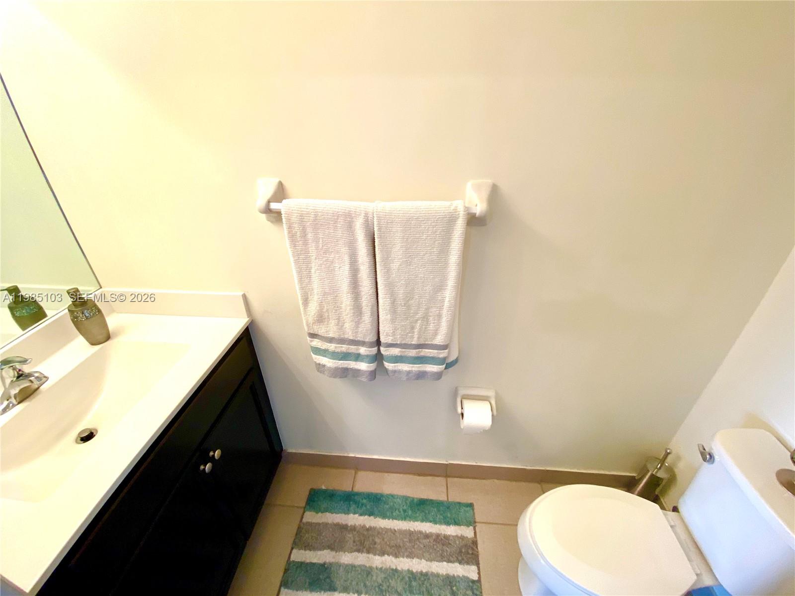 11489 Southwest 250th Street, Unit 11489 Homestead, FL 33032 - Photo 8 of 24 a bathroom with a sink and a mirror