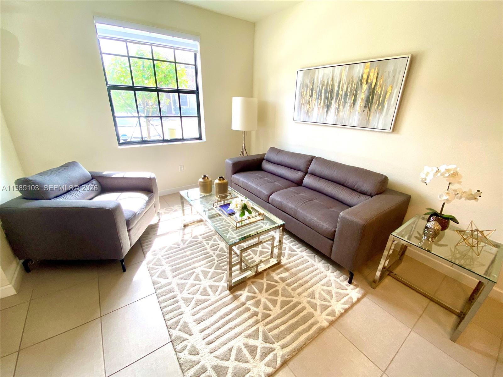 11489 Southwest 250th Street, Unit 11489 Homestead, FL 33032 - Photo 10 of 24 a bedroom with furniture and a window