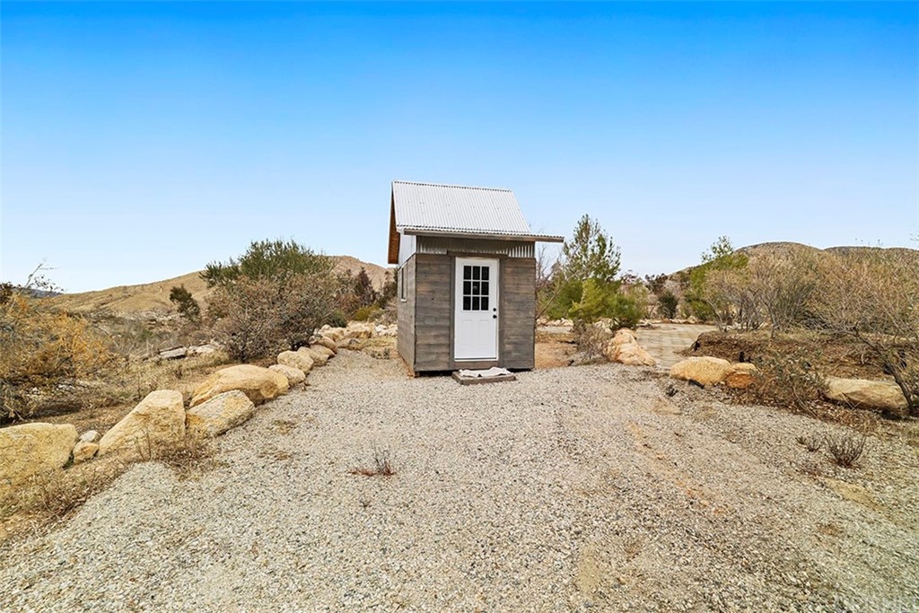 30231 Aliso Canyon Road Palmdale, CA 93550 - Photo 12 of 38 a view of a house with a yard and mountain
