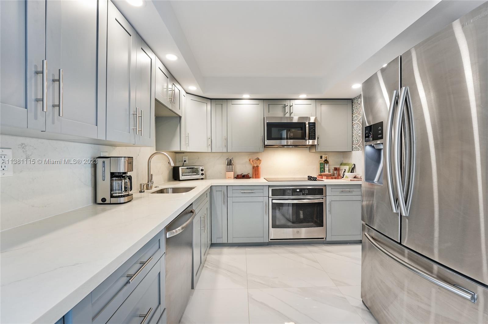 1665 Bay Road, Unit 417 Miami Beach, FL 33139 - Photo 1 of 15 a kitchen with a refrigerator sink and microwave