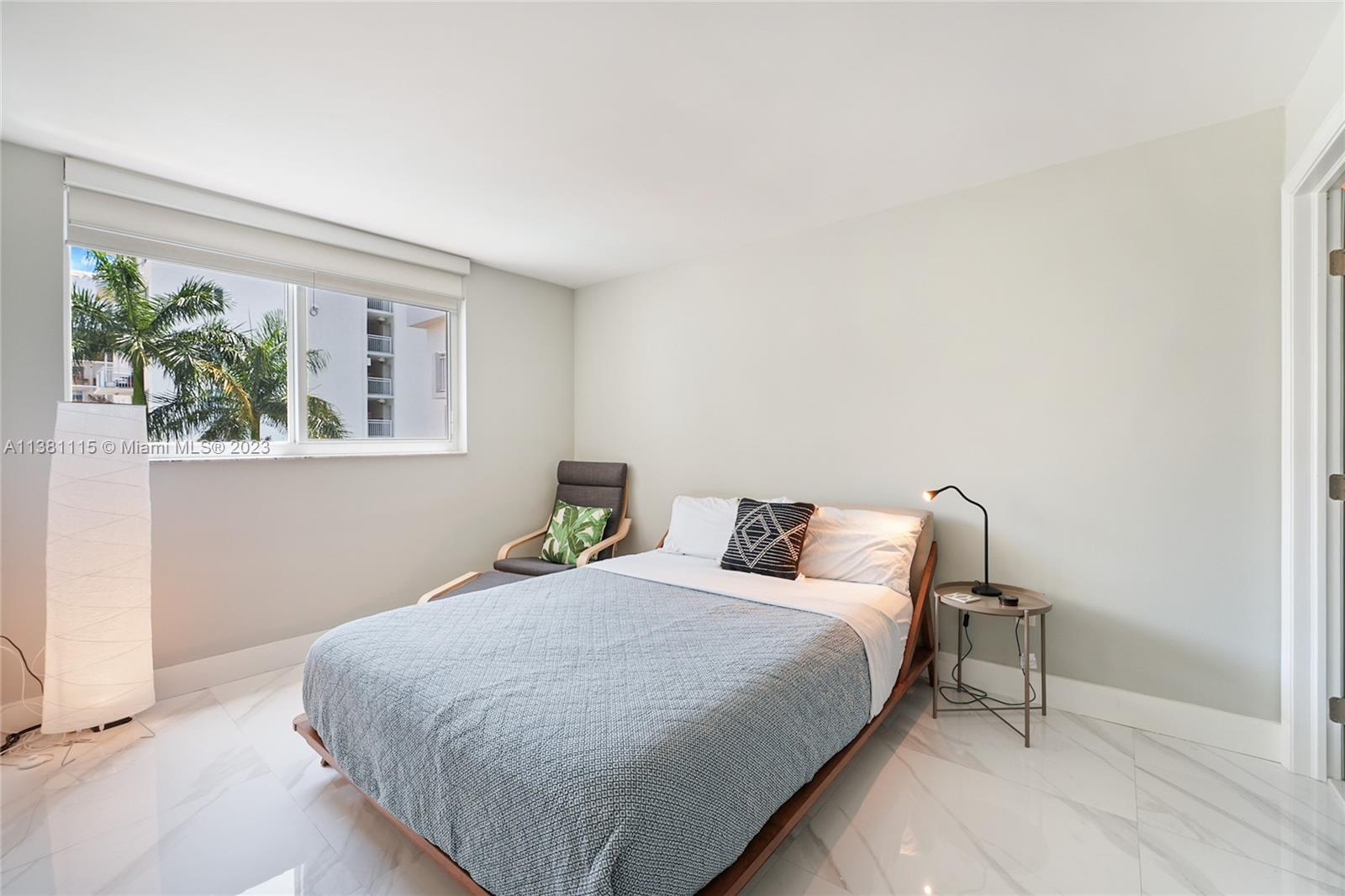 1665 Bay Road, Unit 417 Miami Beach, FL 33139 - Photo 12 of 15 a bedroom with bed and a window