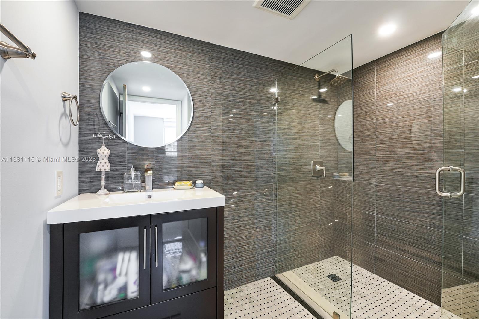 1665 Bay Road, Unit 417 Miami Beach, FL 33139 - Photo 13 of 15 a bathroom with a sink and a mirror