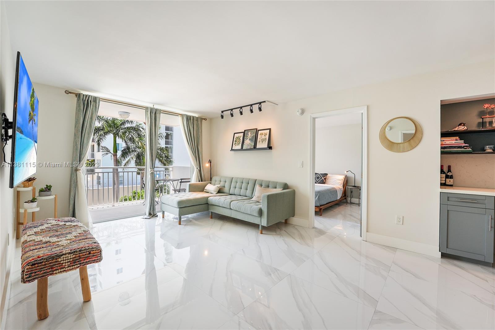 1665 Bay Road, Unit 417 Miami Beach, FL 33139 - Photo 4 of 15 a living room with furniture and a large window