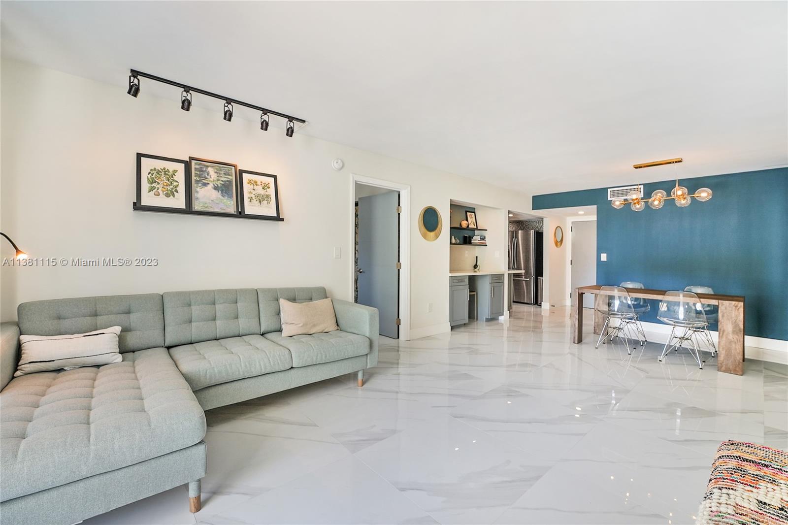 1665 Bay Road, Unit 417 Miami Beach, FL 33139 - Photo 6 of 15 a living room with furniture and kitchen view