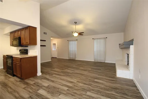 a view of kitchen with wooden floor and electronic appliances