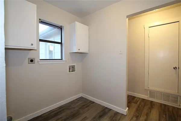 a room with a window and wooden floor