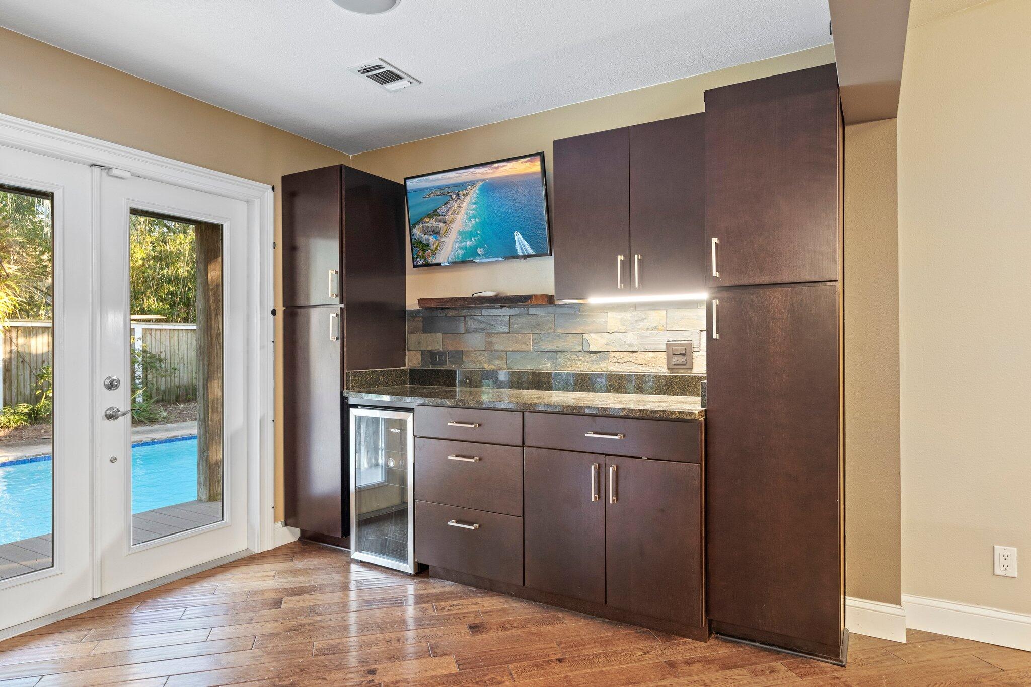 704 Main Street Destin, FL 32541 - Photo 12 of 59 a kitchen with stainless steel appliances granite countertop a refrigerator and a sink