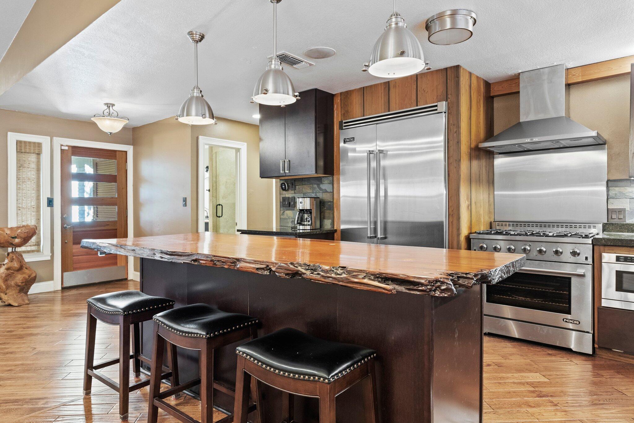 704 Main Street Destin, FL 32541 - Photo 17 of 59 a kitchen with kitchen island granite countertop a stove refrigerator and microwave