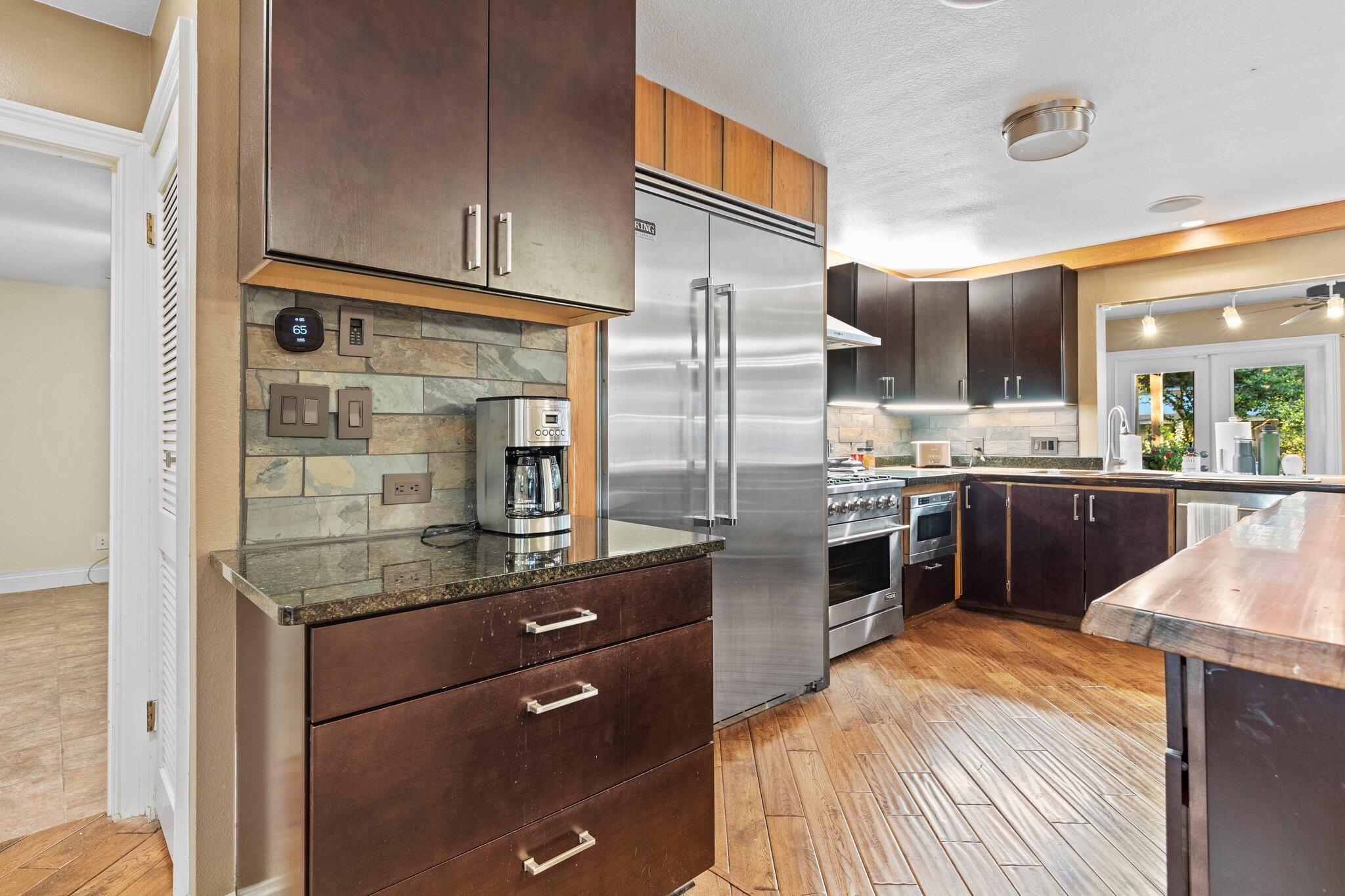 704 Main Street Destin, FL 32541 - Photo 20 of 59 a kitchen with stainless steel appliances granite countertop a refrigerator and a sink
