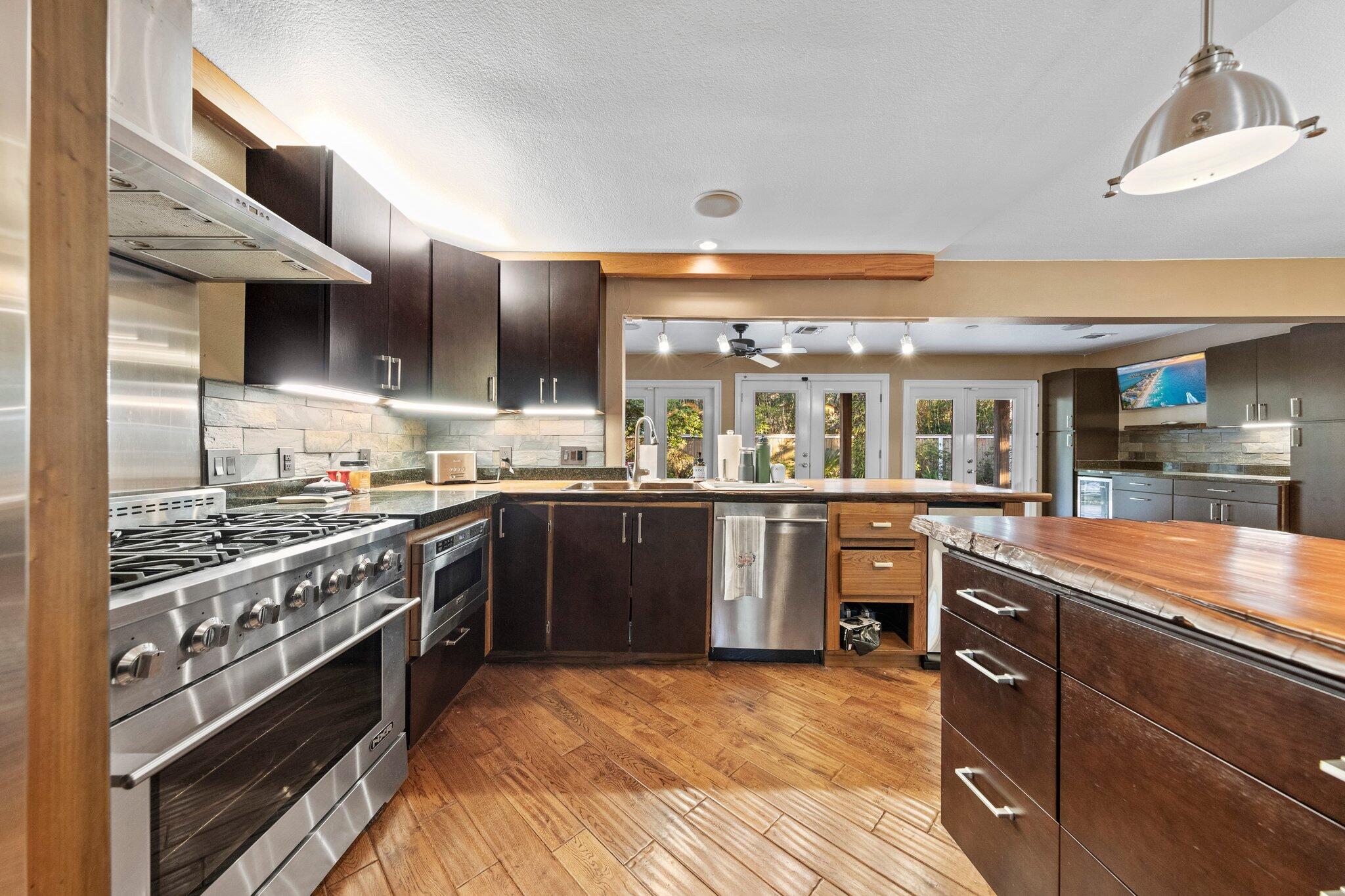 704 Main Street Destin, FL 32541 - Photo 21 of 59 a kitchen with stainless steel appliances granite countertop a stove and a sink
