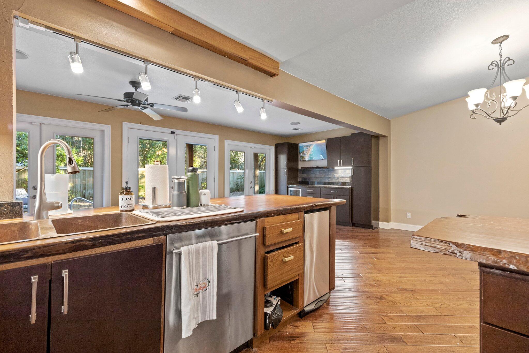 704 Main Street Destin, FL 32541 - Photo 23 of 59 a kitchen with stainless steel appliances granite countertop a sink and wooden floors