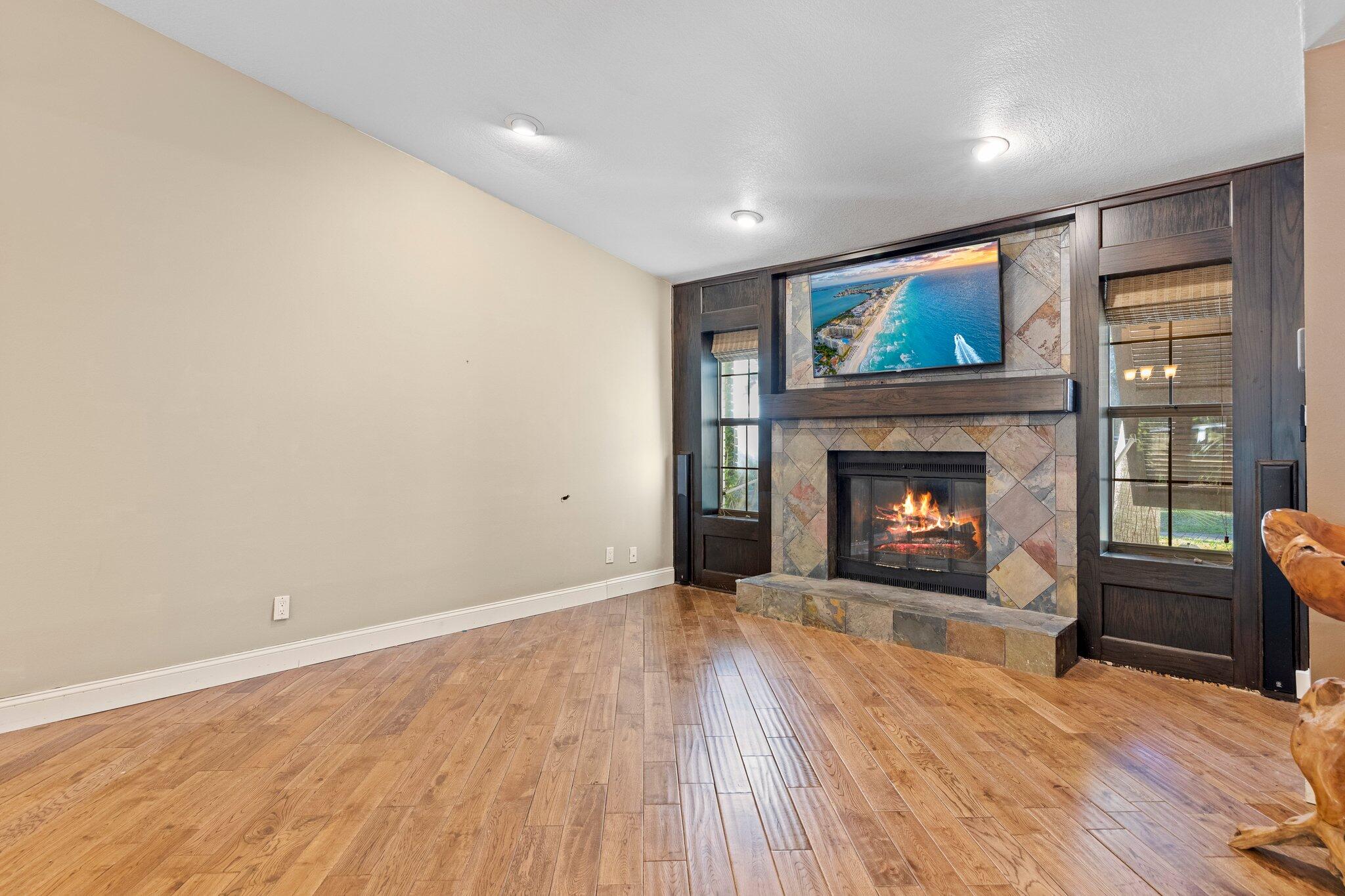 704 Main Street Destin, FL 32541 - Photo 3 of 59 a view of an empty room with a fireplace and wooden floor