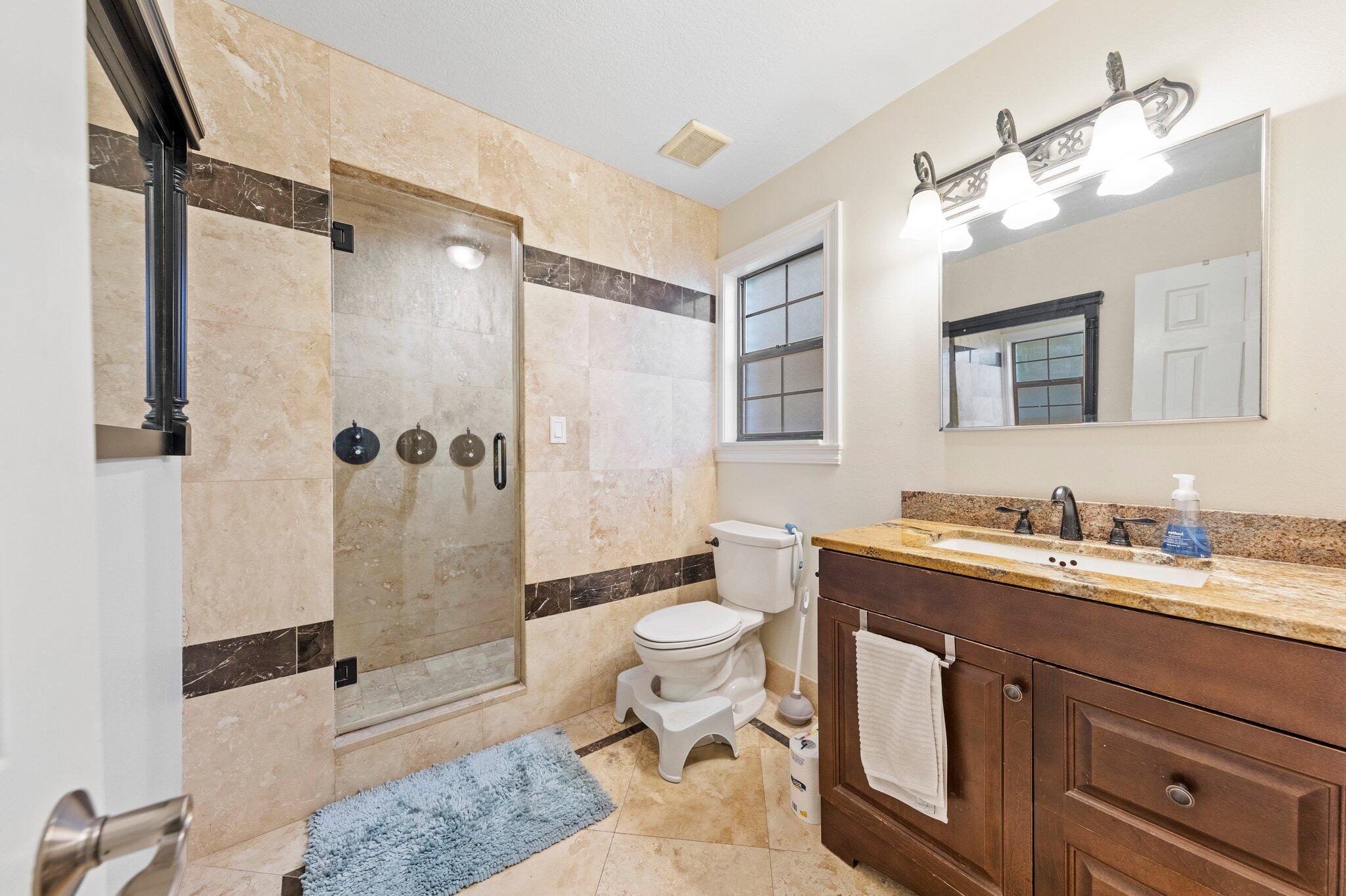 704 Main Street Destin, FL 32541 - Photo 36 of 59 a bathroom with a sink a toilet and shower