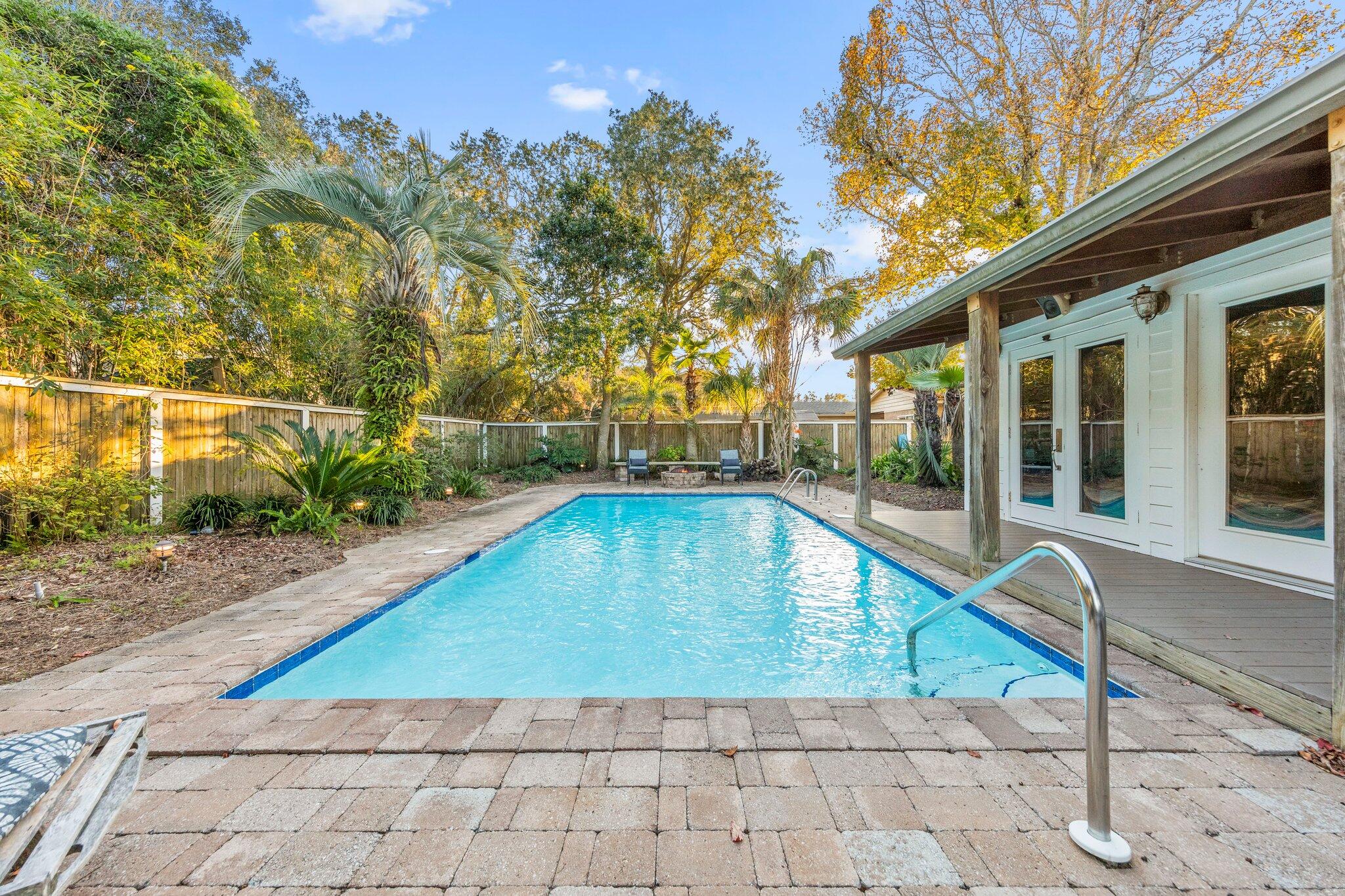 704 Main Street Destin, FL 32541 - Photo 39 of 59 a view of swimming pool with lawn chairs and plants