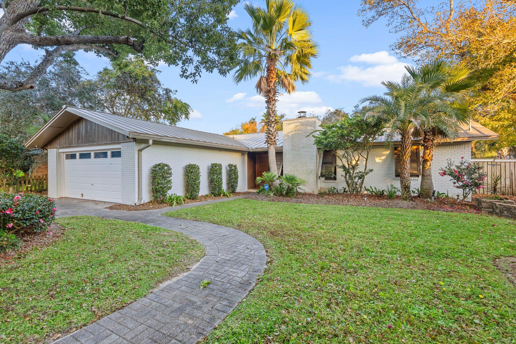 704 Main Street Destin, FL 32541 - Photo 51 of 59 a view of a yard with a house and garden