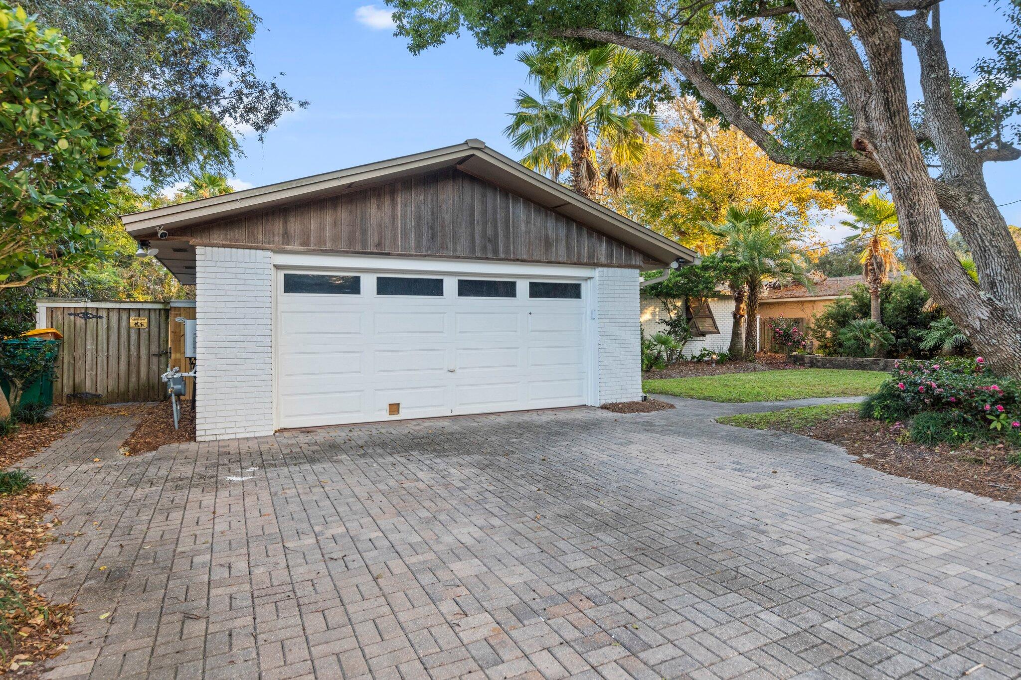 704 Main Street Destin, FL 32541 - Photo 52 of 59 a view of backyard of house with garage