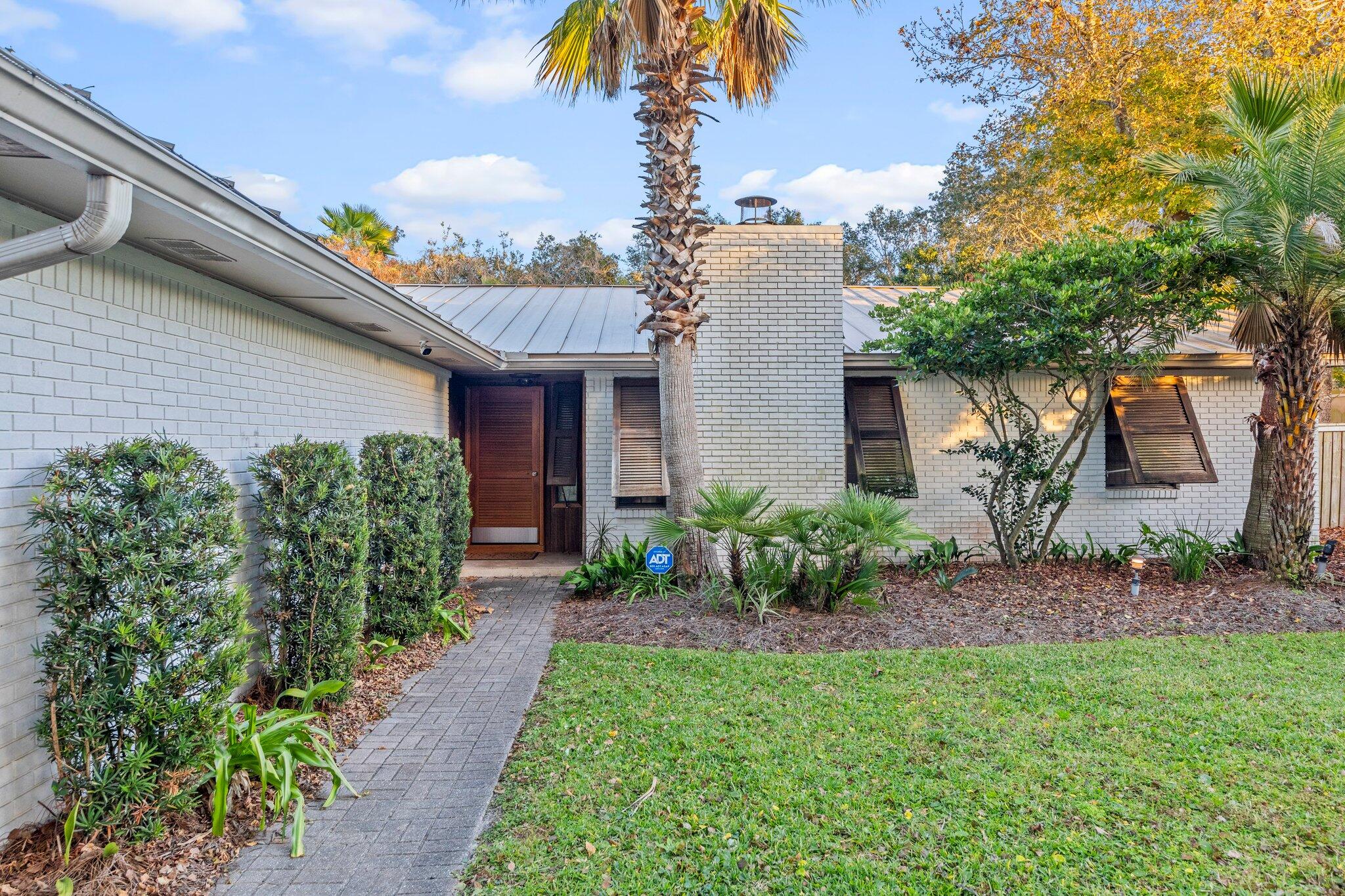 704 Main Street Destin, FL 32541 - Photo 53 of 59 a front view of a house with garden