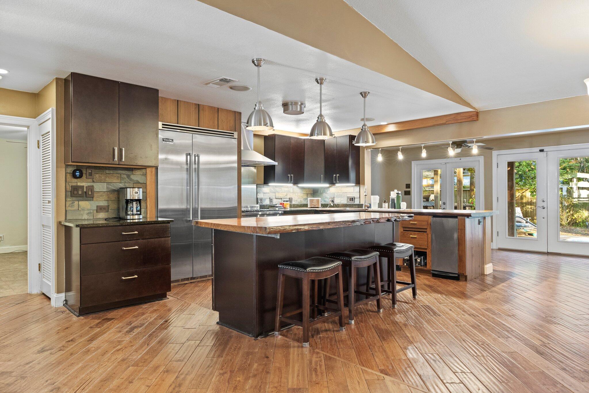 704 Main Street Destin, FL 32541 - Photo 7 of 59 a kitchen with a sink and chairs