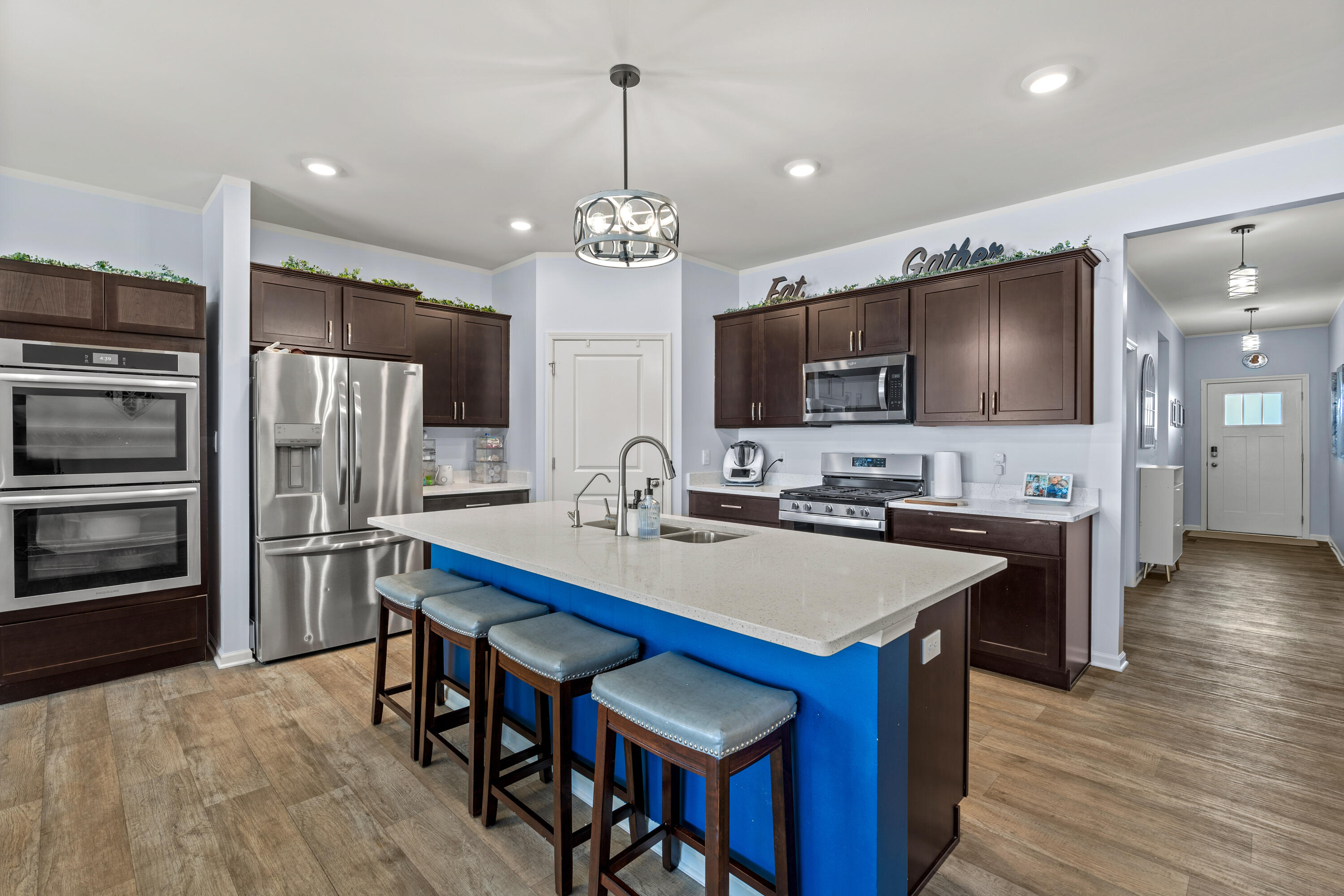 7620 West 105th Place Crown Point, IN 46307 - Photo 5 of 26 a large kitchen with a table chairs refrigerator and microwave