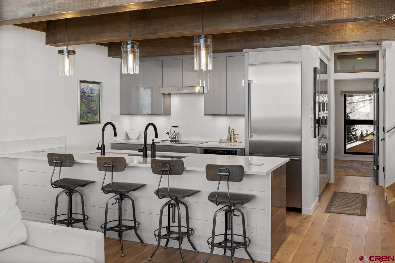 14 Snowmass Road, Unit 308 Crested Butte, CO 81225 - Photo 18 of 40 a kitchen with stainless steel appliances a sink and a refrigerator