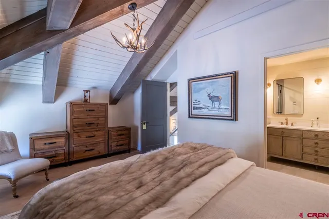 a bedroom with furniture and wooden floor