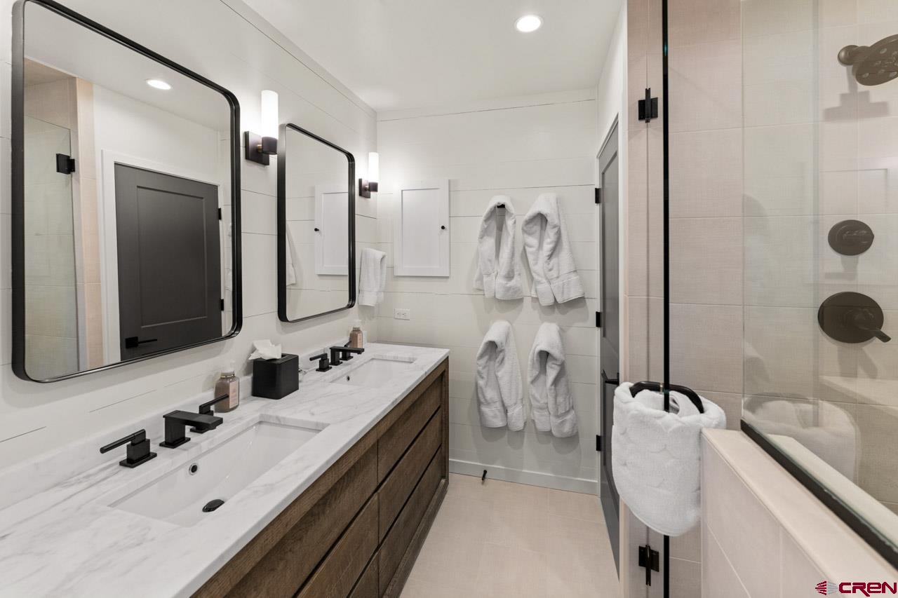 14 Snowmass Road, Unit 308 Crested Butte, CO 81225 - Photo 21 of 40 a bathroom with a double vanity sink mirror and shower