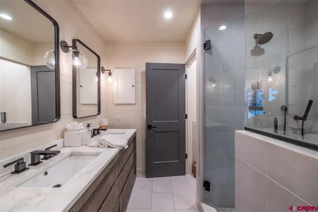 a bathroom with a double vanity sink mirror and double